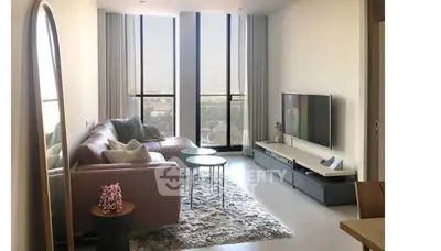 Spacious modern living room with large windows and stylish decor