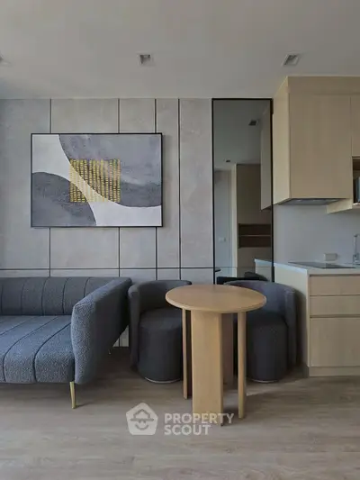 Modern living room with stylish furniture and abstract art on the wall