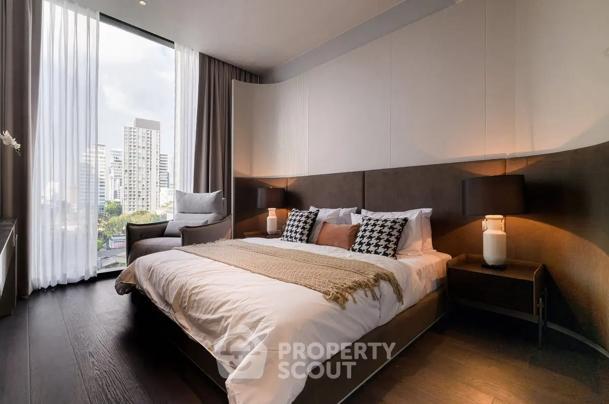 Luxurious modern bedroom with city view, featuring elegant decor and ample natural light.