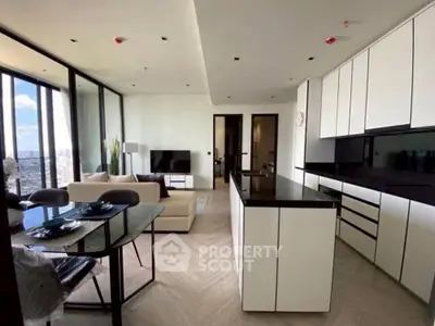 Modern open-plan living room and kitchen with city view and sleek design.