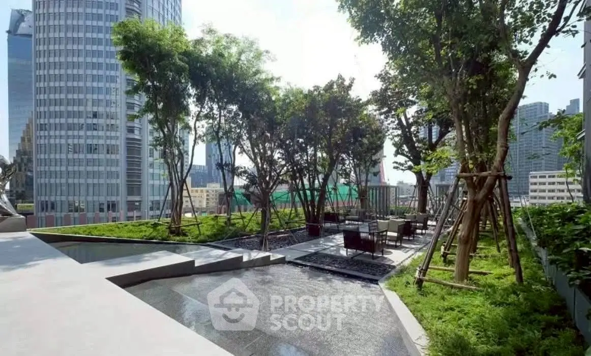 Luxurious urban rooftop garden with seating area and stunning city views.