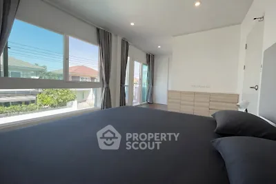 Spacious bedroom with large windows and modern decor