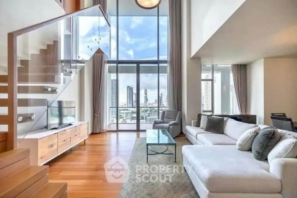 Luxurious high-rise living room with stunning city view and modern staircase