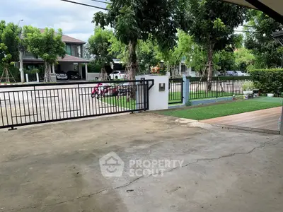 Spacious driveway with gated entrance in a serene neighborhood