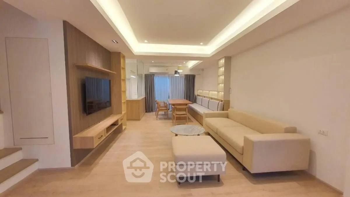 Spacious modern living room with elegant furniture and ambient lighting