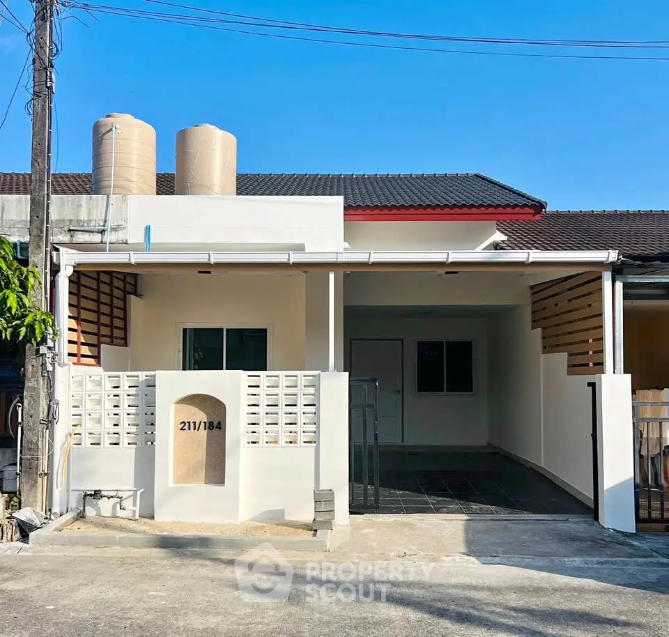 Charming single-story home with modern facade and spacious driveway, perfect for family living.