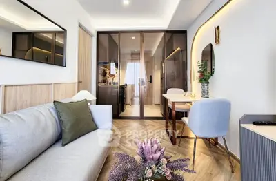 Modern living room with stylish decor and open layout, featuring elegant furniture and ambient lighting.