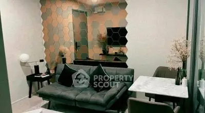 Stylish modern living room with hexagonal mirror wall and sleek furniture