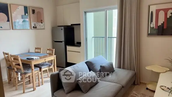 Modern living room with cozy sofa, dining area, and balcony access in stylish apartment.