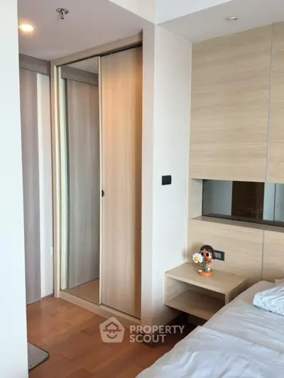 Modern bedroom with wooden flooring and built-in wardrobe