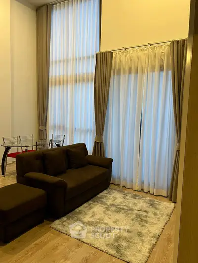 Luxurious living room with high ceilings and elegant curtains