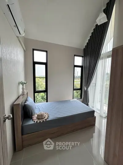 Modern bedroom with large windows and stylish decor