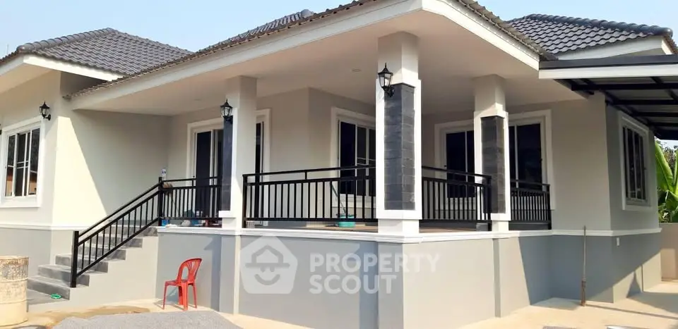 Modern single-story house with spacious balcony and stylish exterior design.