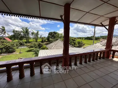 Spacious balcony with scenic countryside views and traditional design elements.