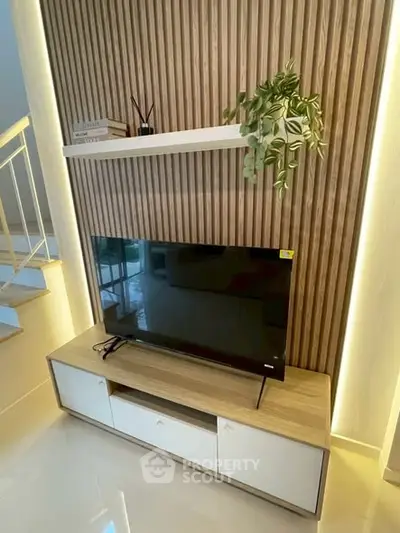 Modern living room with stylish TV stand and decorative wall paneling