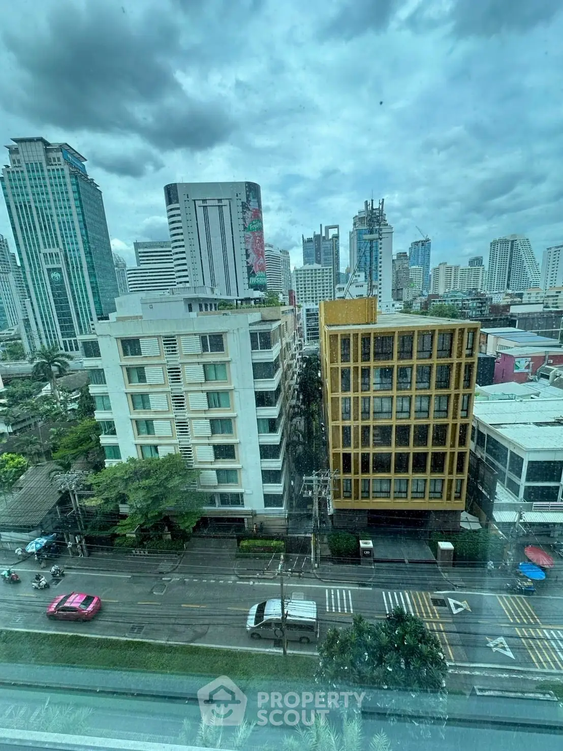 Stunning cityscape view showcasing modern high-rise buildings under a dramatic cloudy sky.