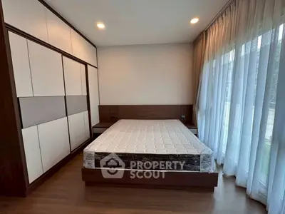 Spacious bedroom with large windows and modern design