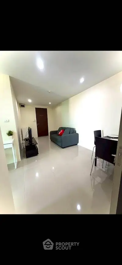 Modern living room with sleek furniture and bright lighting, perfect for cozy gatherings.