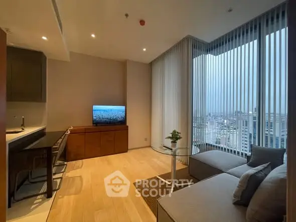 Modern living room with city view, featuring sleek furniture and floor-to-ceiling windows.