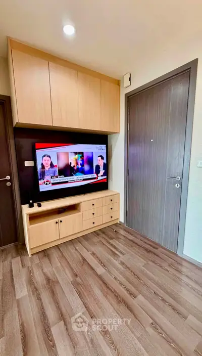 Modern living room with wooden flooring and built-in TV cabinet