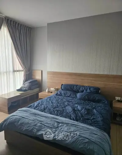Cozy bedroom with modern decor and natural light, featuring a comfortable bed and stylish furnishings.