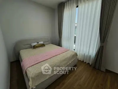 Cozy bedroom with elegant curtains and stylish bed in modern apartment