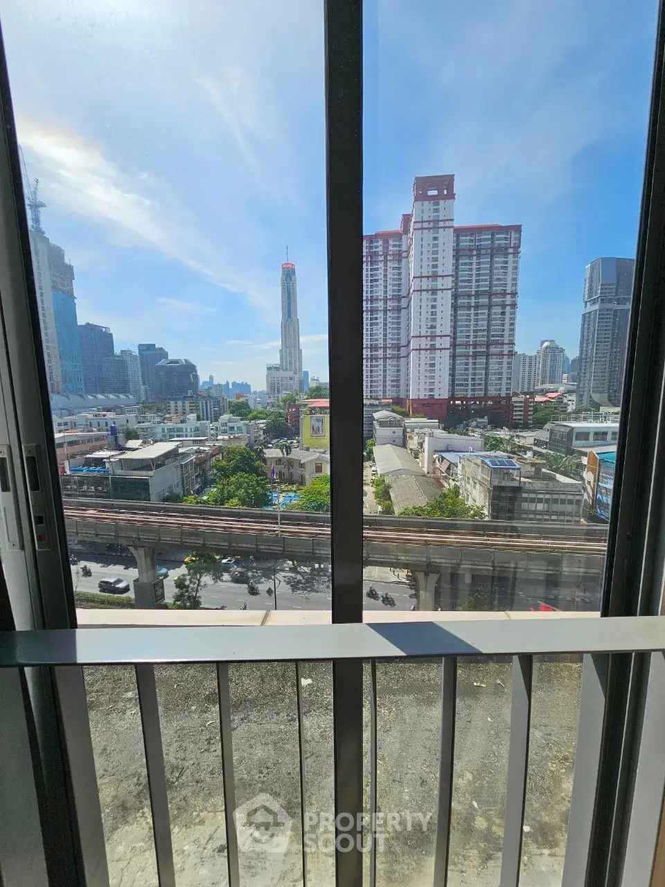 Stunning cityscape view from a high-rise balcony with modern urban skyline.