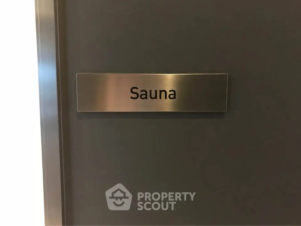 Modern sauna door with sleek metallic sign in upscale residential building
