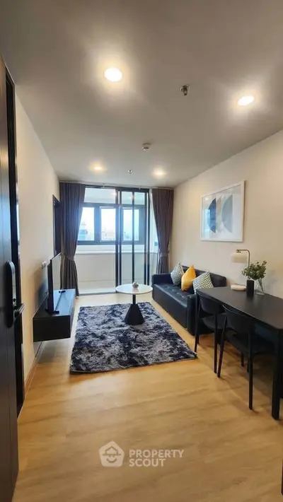 Modern living room with stylish decor and large windows offering natural light.