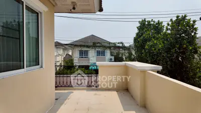 Spacious balcony with scenic view of suburban neighborhood and lush greenery.
