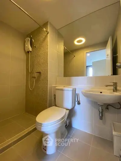 Modern bathroom with sleek fixtures and spacious shower area