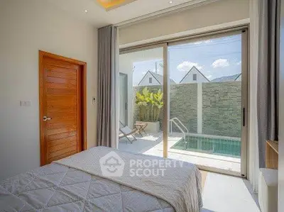 Luxurious bedroom with poolside view and sliding glass doors