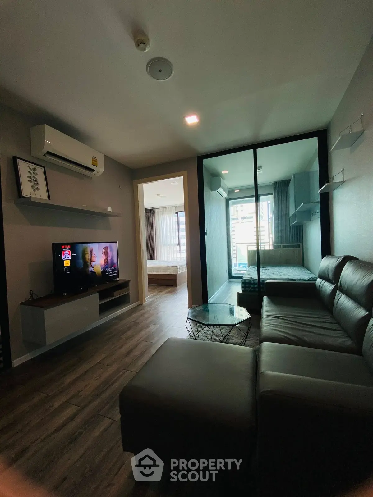 Modern living room with sleek furniture and large window view