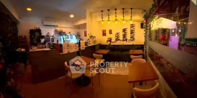 Charming cafe-style interior with cozy seating and ambient lighting, perfect for social gatherings.