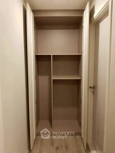Spacious built-in storage closet with open shelving in modern apartment