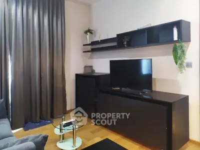 Modern living room with sleek black furniture and stylish decor