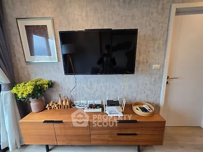 Modern living room with wall-mounted TV and stylish wooden console