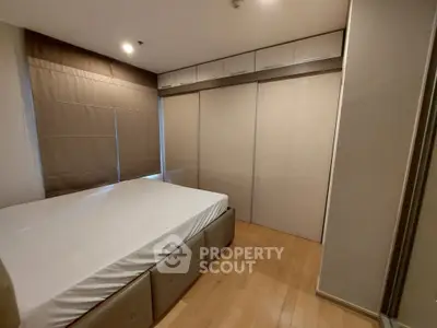 Spacious bedroom with built-in storage and large windows for natural light.