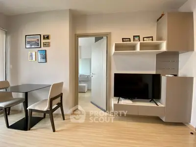 Modern living room with sleek furniture and wall-mounted TV, showcasing contemporary interior design.