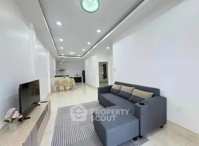 Spacious modern living room with sleek furniture and open layout, perfect for entertaining and relaxation.