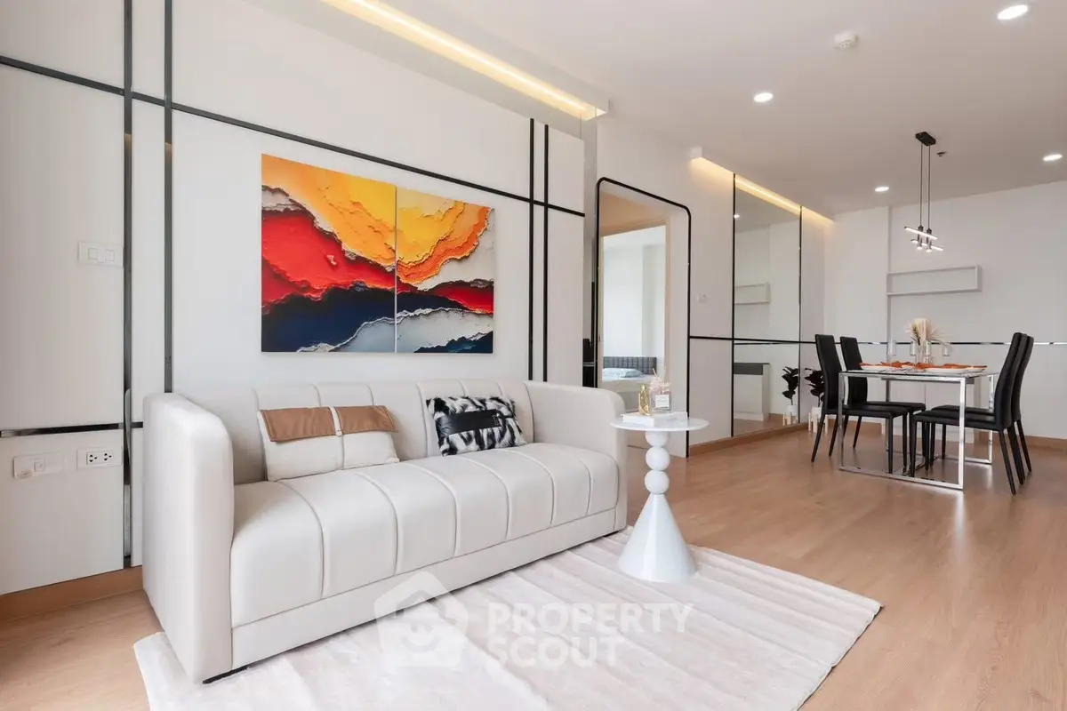Modern living room with elegant decor and dining area in open layout apartment.