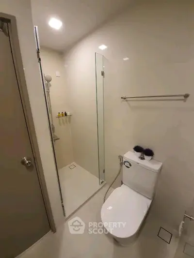 Modern bathroom with sleek shower and toilet in minimalist design