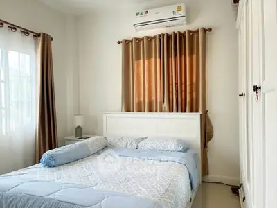 Cozy bedroom with natural light and elegant decor