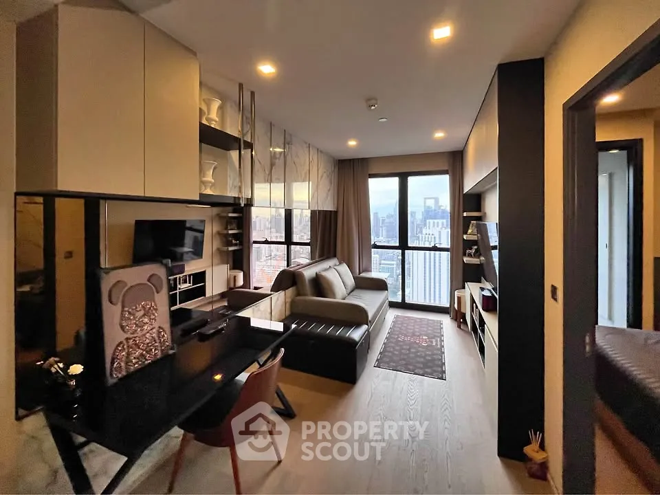 Modern living room with city view, stylish furniture, and open layout in high-rise apartment.