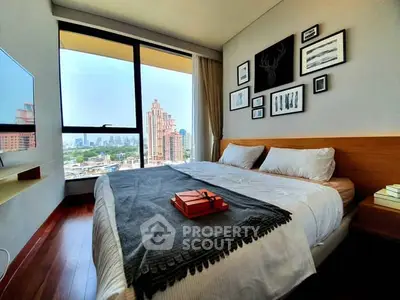 Modern bedroom with city view, stylish decor, and cozy ambiance in urban apartment.