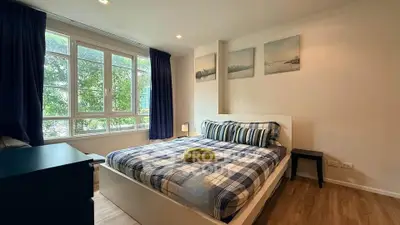 Cozy bedroom with large window and stylish decor in modern apartment