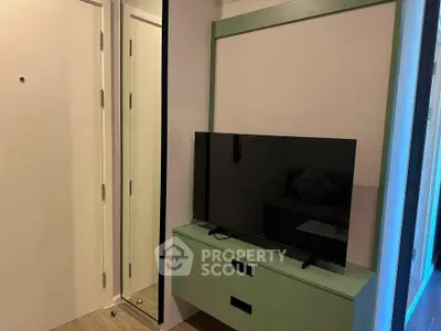 Modern living room with sleek TV stand and wall-mounted mirror, perfect for stylish urban living.