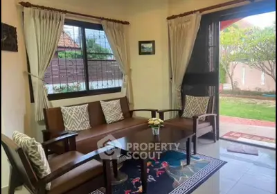 Charming living room with garden view and cozy seating area.