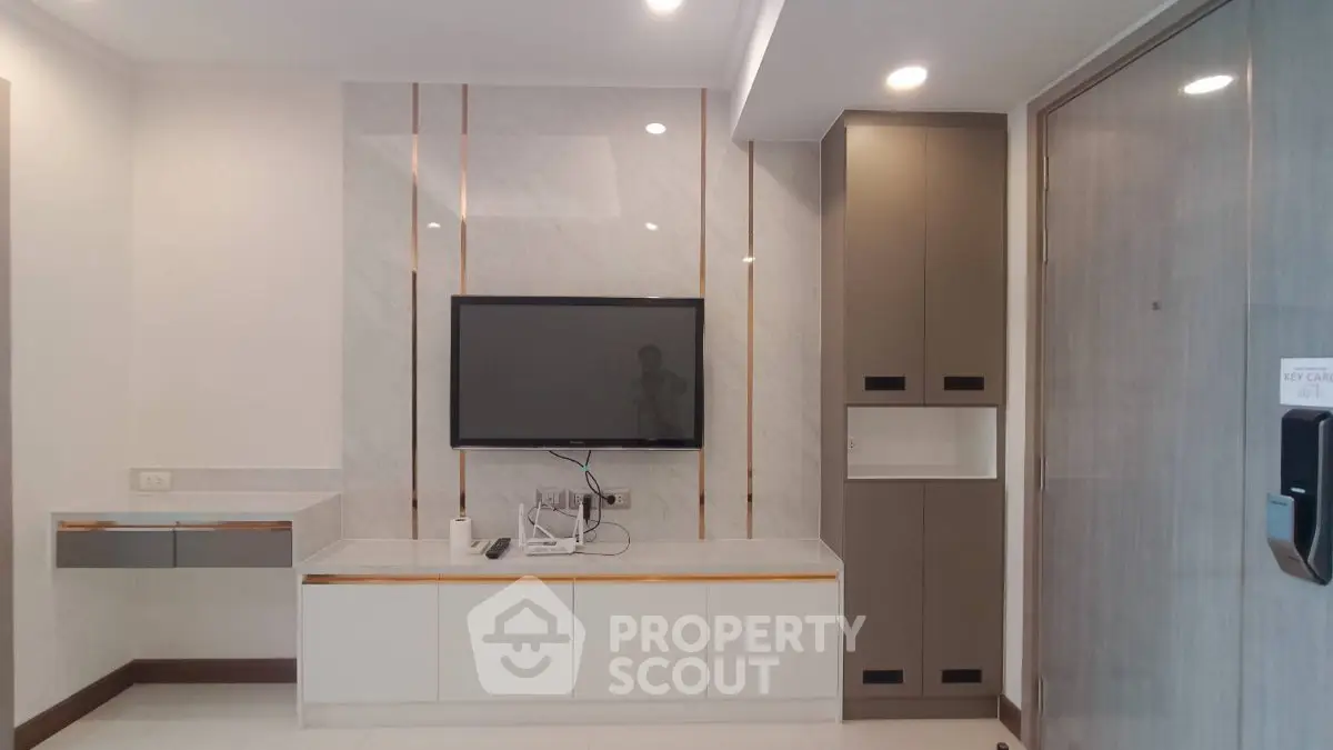Modern living room with sleek TV setup and stylish cabinetry