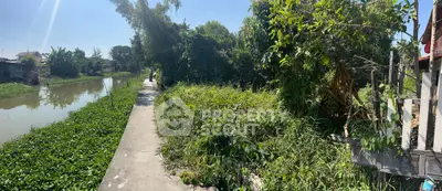 Scenic riverside property with lush greenery and potential for development.